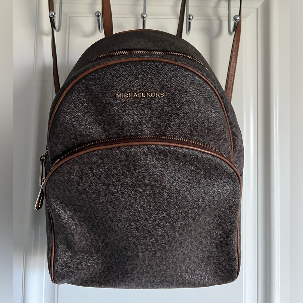 Michael Kors, Brown Backpack. Measurements 12" (L) X 16.5" (H) X 5" (D)